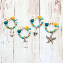 Load image into Gallery viewer, 4 Beachy Teal &amp; Turquoise Starfish Wine Glass Charms
