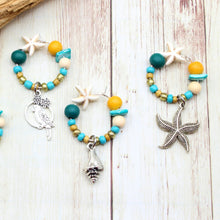 Load image into Gallery viewer, 4 Beachy Teal &amp; Turquoise Starfish Wine Glass Charms
